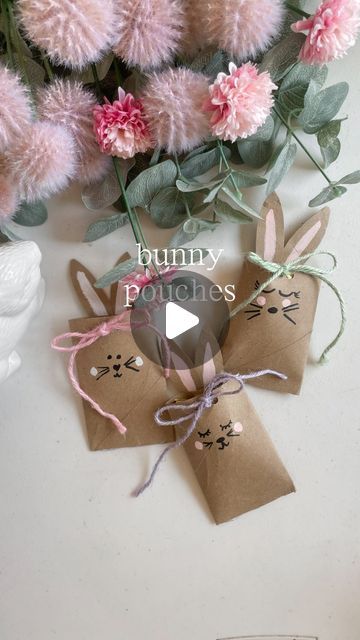 some pink flowers and brown paper tags on a white surface with the words bunny ponies