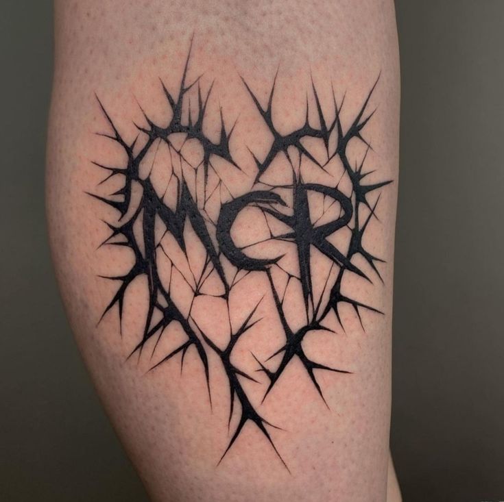 a tattoo on the leg of a person with a heart and thorns in it