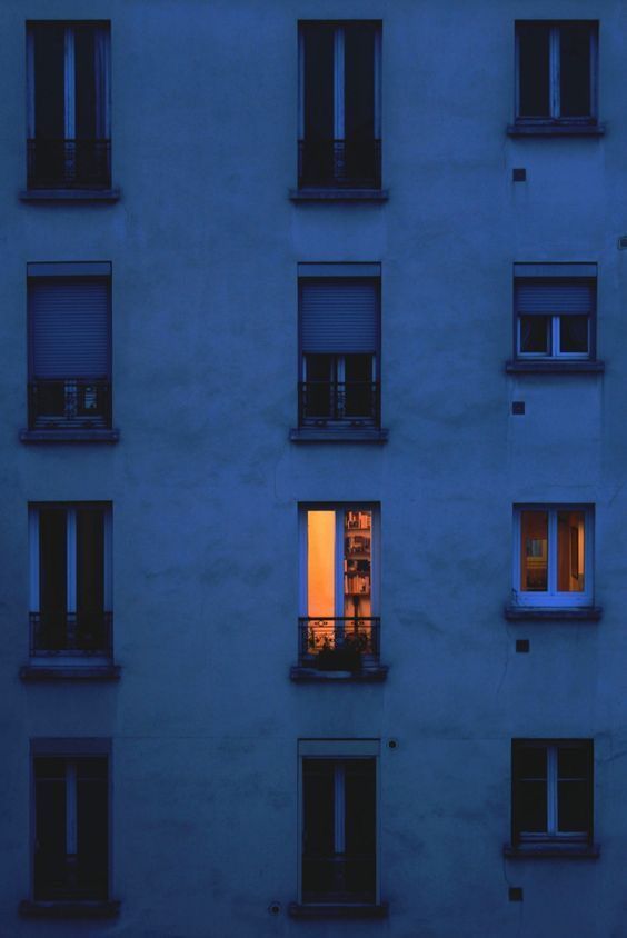 an apartment building with many windows at night