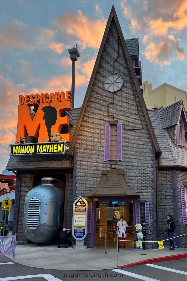 a building with a giant clock on the side of it's face and people standing outside