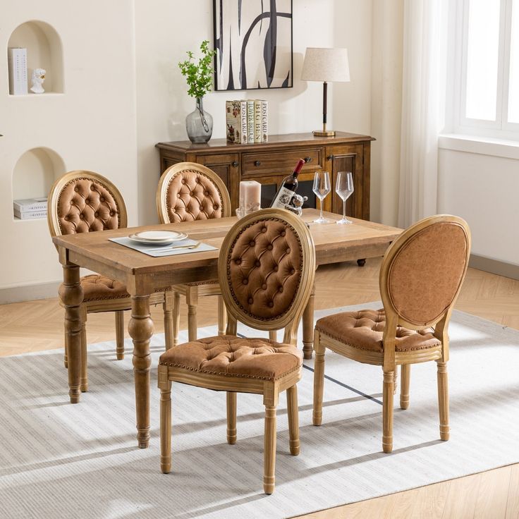 a dining room table and chairs with beige upholstered fabric on the chair backs