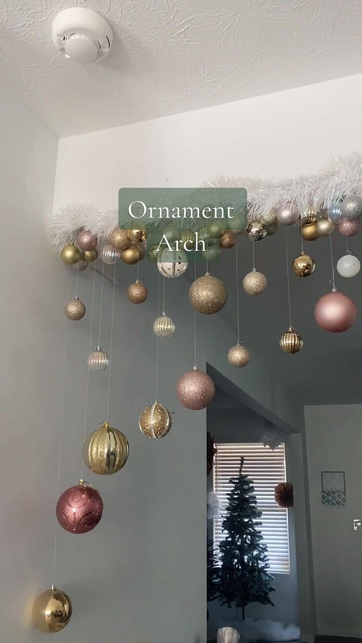 an ornament arch with ornaments hanging from it's ceiling and the name on top