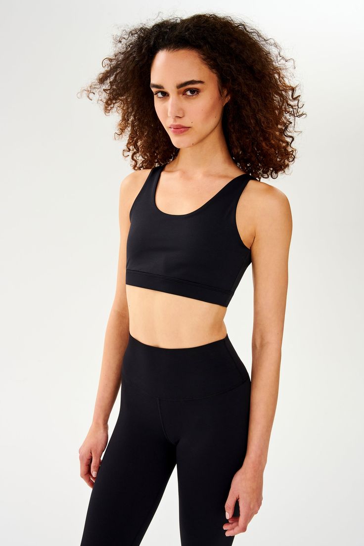 Front view of woman with curly dark wearing black bra  with black leggings Functional Sports Bra With Built-in Bra For Training, Compressive Training Bra With Built-in Padding, Functional Gym Bra With Built-in Padding, Functional Sports Bra With Built-in Bra For Gym, Functional Compressive Sports Bra With Built-in Bra, Compressive Sports Bra With Built-in Bra For Sports, Compressive Sports Bra With Built-in Padding For Light Sports, Sporty Black Sports Bra With Built-in Bra, Black Sports Bra With Built-in Bra For Gym