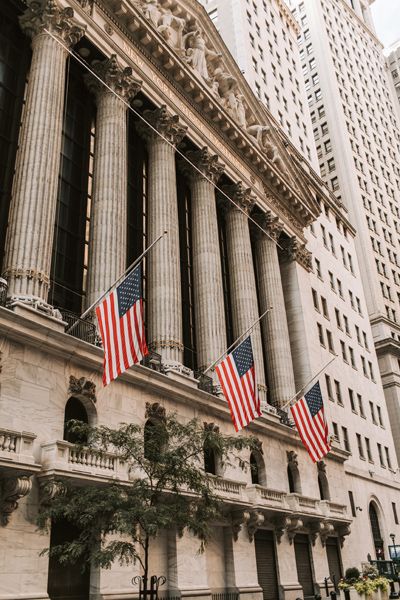 the new york stock exchange building with american flags