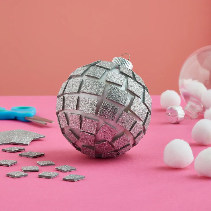 a pink table topped with silver and white objects