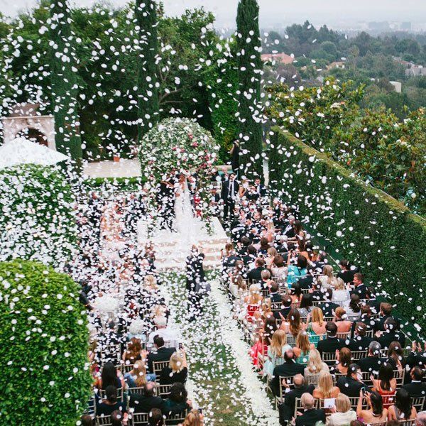 the wedding ceremony is being showered with confetti