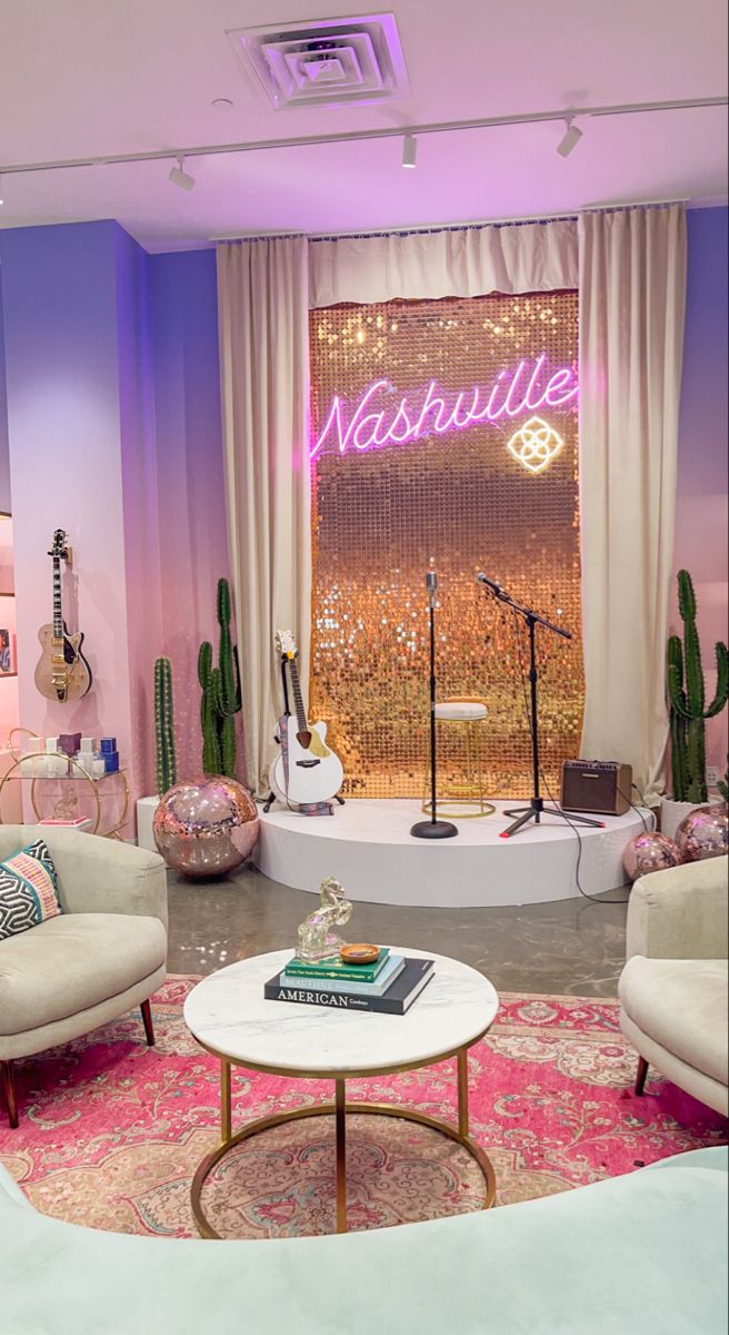 a living room filled with furniture and a neon sign