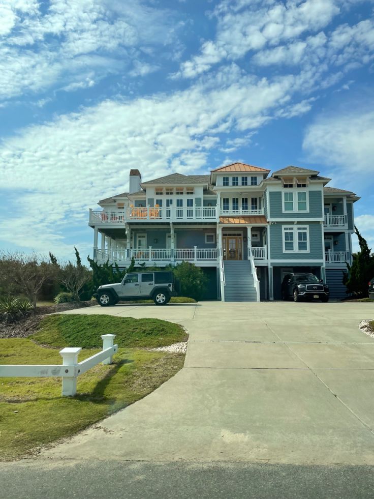 a large house sitting on top of a lush green field