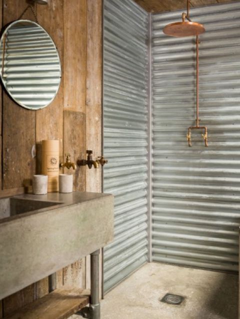 a bathroom with a sink, mirror and shower stall in the middle of the room