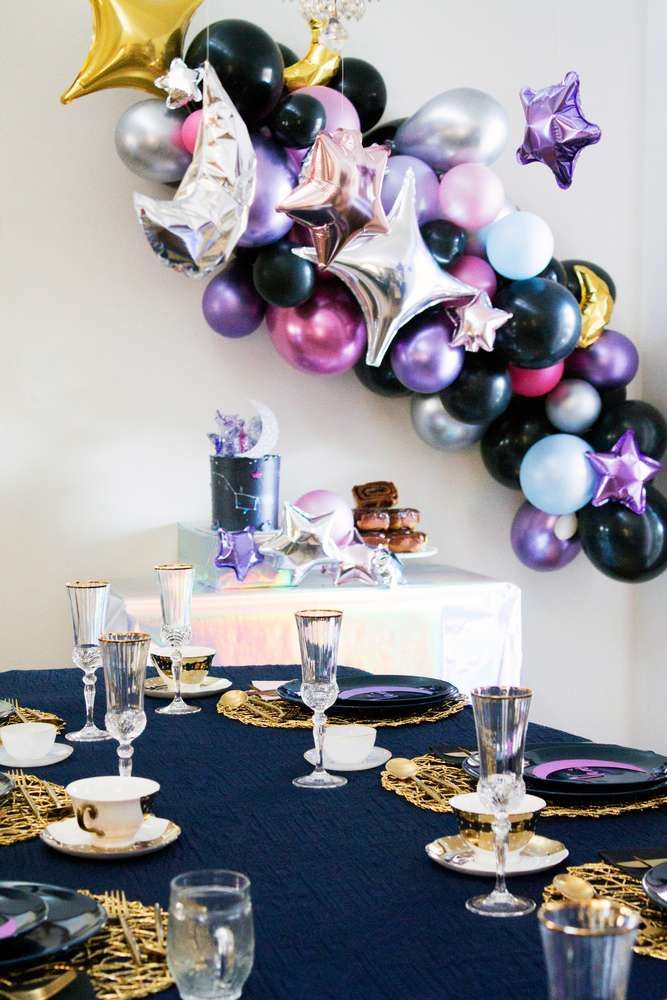 the table is set for a party with balloons