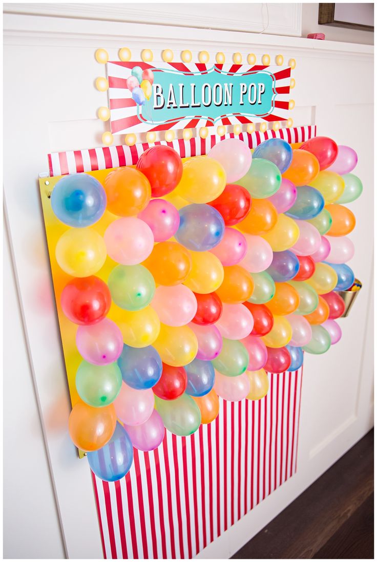 a balloon pop sign hanging from the side of a door