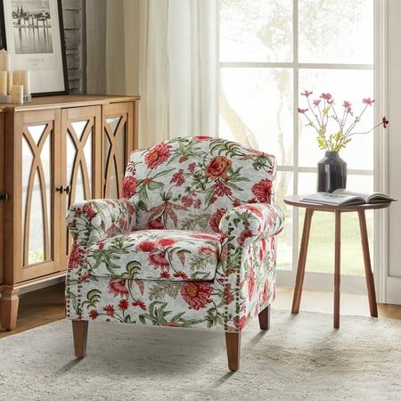 a living room with a floral chair and side table