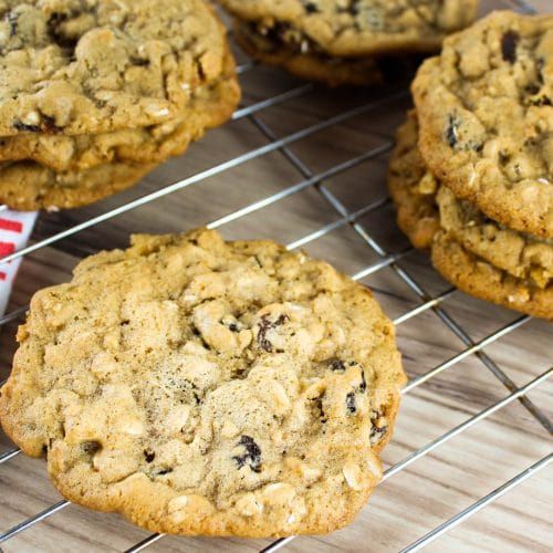 chocolate chip cookies cooling on a rack with a red and white striped paper wrapper