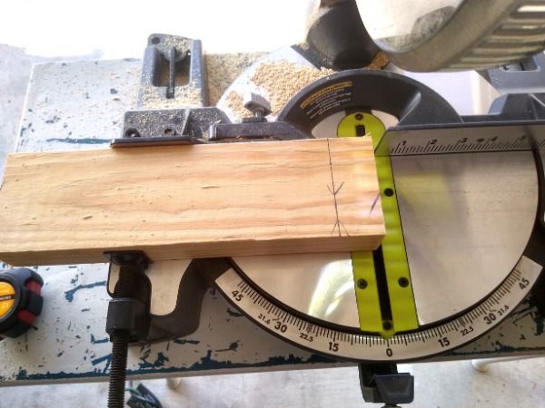 a circular saw is being used to cut a piece of wood with a tape measure