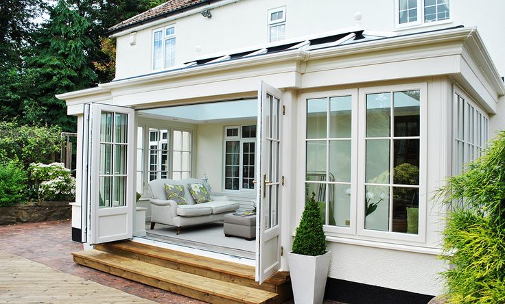 a white house with an open patio and sitting area