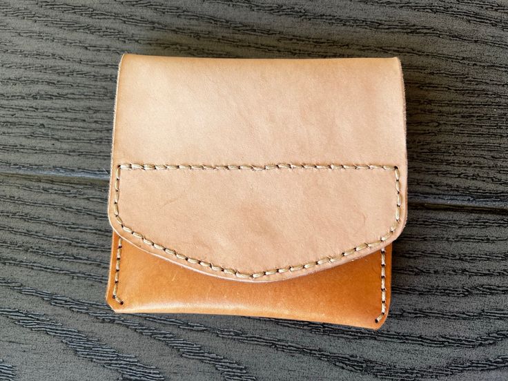 This handmade leather pouch offers two interior pockets and a hidden magnetic snap to give it a sleek finish.  Measurements: 120mm X 110mm when snapped 120mm X 212mm when open -- [ CARE INSTRUCTIONS ] -- * Remove dust and dirt with a soft brush or cloth. * Refrain from using detergents or chemicals. Use a damp cloth to wipe your wallet lightly and allow to air dry. * Allow them to dry naturally and never under an artificial heat source. * If the leather gets too dry, apply a neutral leather crea Leather Envelope Coin Purse For Everyday, Leather Envelope Coin Purse With Coin Pocket, Rectangular Hand-stitched Coin Purse For Daily Use, Leather Hand-stitched Coin Purse For Everyday Use, Leather Bifold Pouch With Card Slots, Hand-stitched Leather Rectangular Coin Purse, Hand-stitched Rectangular Leather Coin Purse, What Is Advertising, Veg Tan Leather