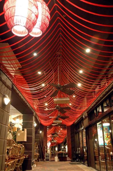 the ceiling is covered in red string lights