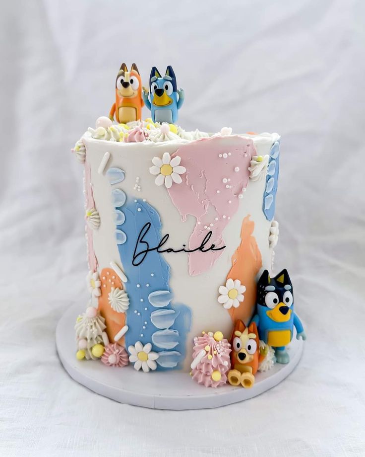 a decorated cake with cartoon characters on it