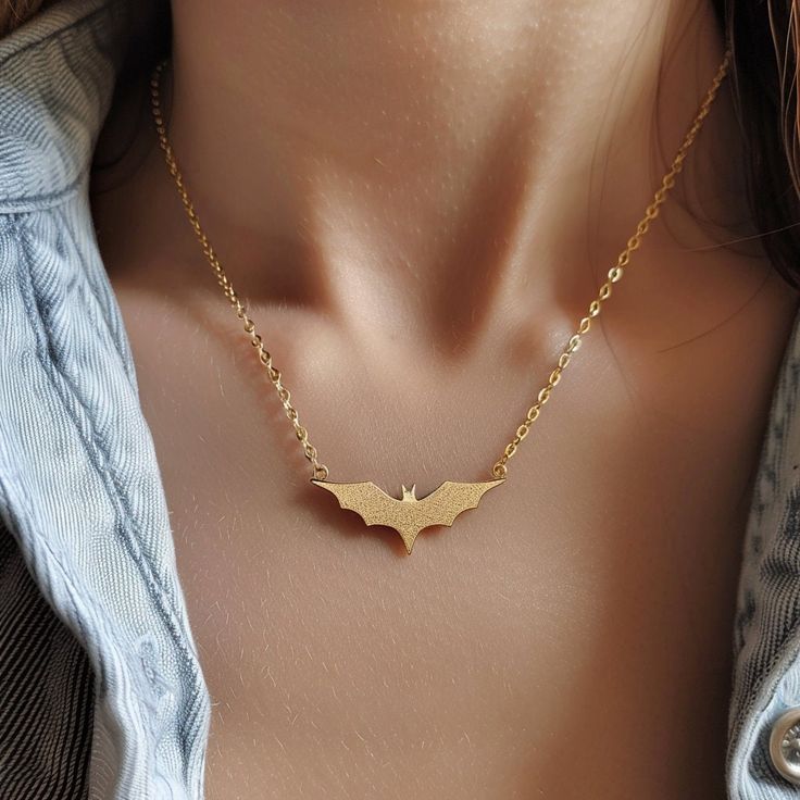 14k Gold Bat Charm Necklace, Gold Halloween Bat Necklace, Tiny Gold Bat Necklace, Spooky Bat Necklace, Dainty Halloween Bat Charm Necklace 🌺Item Details🌺 Item Name : Halloween Bat Necklace Metal : 925 Silver Necklace Size  : 16 Inch Pendant Size : 25*20MM                                                                  🌊 *About Us: Natural World Jewelry* 🐚 At Natural World Jewelry, we're passionate about bringing the serene beauty of the ocean to your everyday life. Our artisanal jewelry pie Gold Jewelry For Costume Party, Gold Necklace For Halloween Party, Gold Halloween Party Jewelry, Halloween Clavicle Chain Jewelry Gift, Halloween Gift Clavicle Chain Jewelry, Adjustable Chain Jewelry For Halloween Party, Halloween Party Jewelry With Adjustable Chain, Halloween Pendant Necklaces With Adjustable Chain, Gothic Gold Necklace With Clavicle Chain