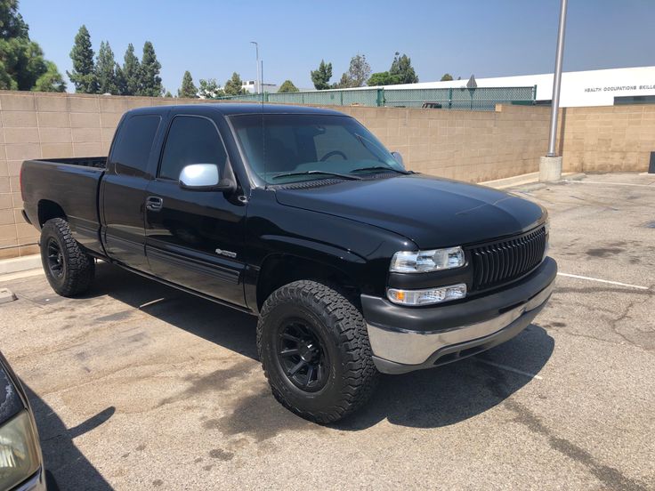 a black truck parked in a parking lot