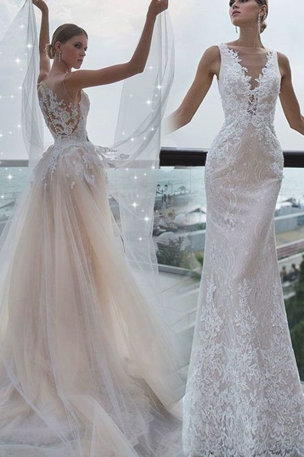 two women in wedding dresses standing on a balcony with their arms up and hands out