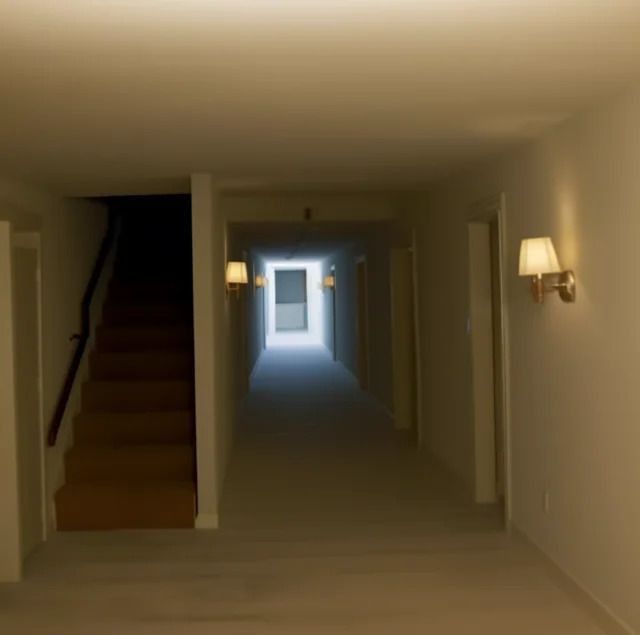 an empty hallway with light coming in from the door and stairs leading to another room