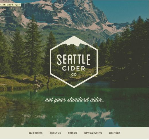 the seattle cider website homepage is displayed on a computer screen, with trees and mountains in the background