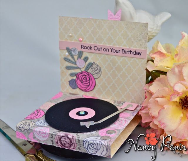 a birthday card with a record player next to flowers and scissors on a table top