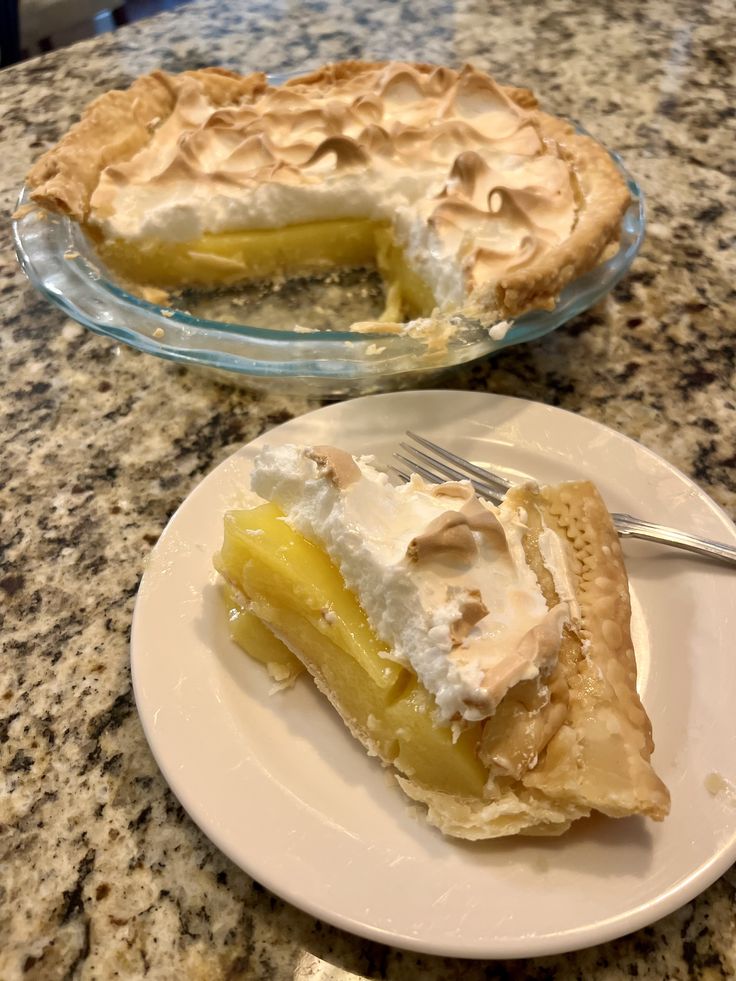 two plates with pies on them sitting on a counter top next to each other