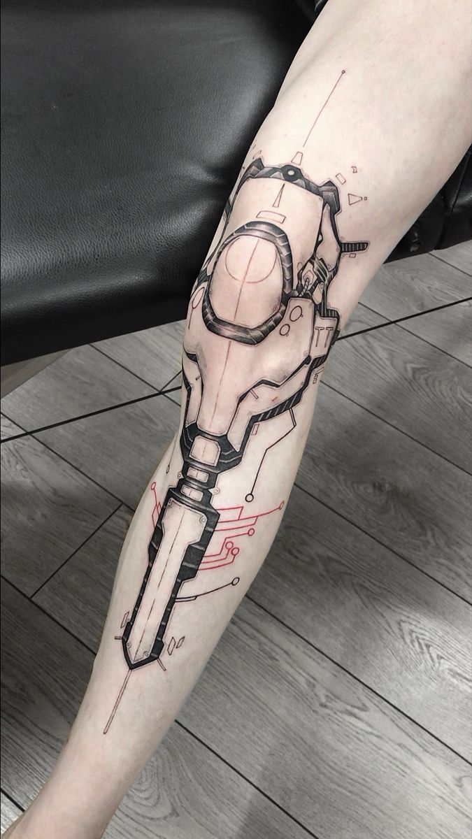 a man's leg with a tattoo on it that has a wrench in it