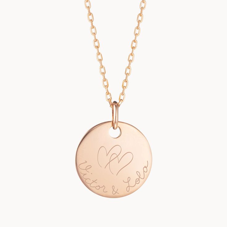 Celebrate loving connections through our Personalized Merci Maman Necklace. Hold your loved ones close by hand-engraving two special names underneath our signature MM logo and create a meaningful gift to cherish.18K Champagne Gold Plated, 925 Sterling Silver or 18K Rose Gold PlatedCharm sizes: Medium Flat Disc 0.8 x 0.8Secure clasp fasteningCharms are removable from this chain and can be worn on all Merci Maman chain lengthsHand-engraved in our Paris and Paris workshopSent with love in a complim Classic Necklace With Engraving Option, Rose Gold Medallion Necklace For Anniversary, Heart Pendant Necklace With Engraving Option For Wedding, Engraved Custom Nameplate Necklace For Anniversary, Rose Gold Charm Necklaces For Anniversary, Heart Pendant Wedding Jewelry With Engraving Option, Wedding Heart Pendant Jewelry With Engraving Option, Heart Pendant Jewelry With Engraving Option For Weddings, Wedding Jewelry With Engraving Option, Heart Pendant