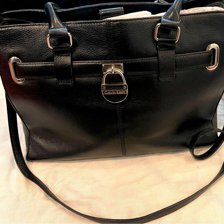 Excellent Condition. Received As A Gift Years Ago, But Never Used It. Has Been Stored In Dust Bag In Closet. Smoke Free Home. Calvin Klein Leather Shoulder Bag With Adjustable Strap, Calvin Klein Classic Shoulder Bag, Classic Calvin Klein Leather Bags, Classic Calvin Klein Satchel Shoulder Bag, Classic Calvin Klein Shoulder Bag For Daily Use, Black Calvin Klein Bag For Formal Occasions, Calvin Klein Black Formal Bag, Calvin Klein Rectangular Leather Shoulder Bag, Calvin Klein Leather Rectangular Shoulder Bag