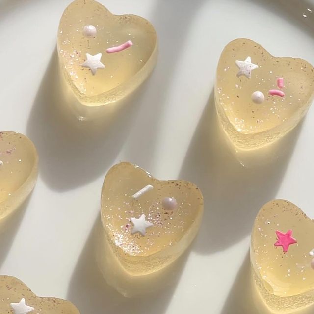 several pieces of cake sitting on top of a white plate with pink and white stars