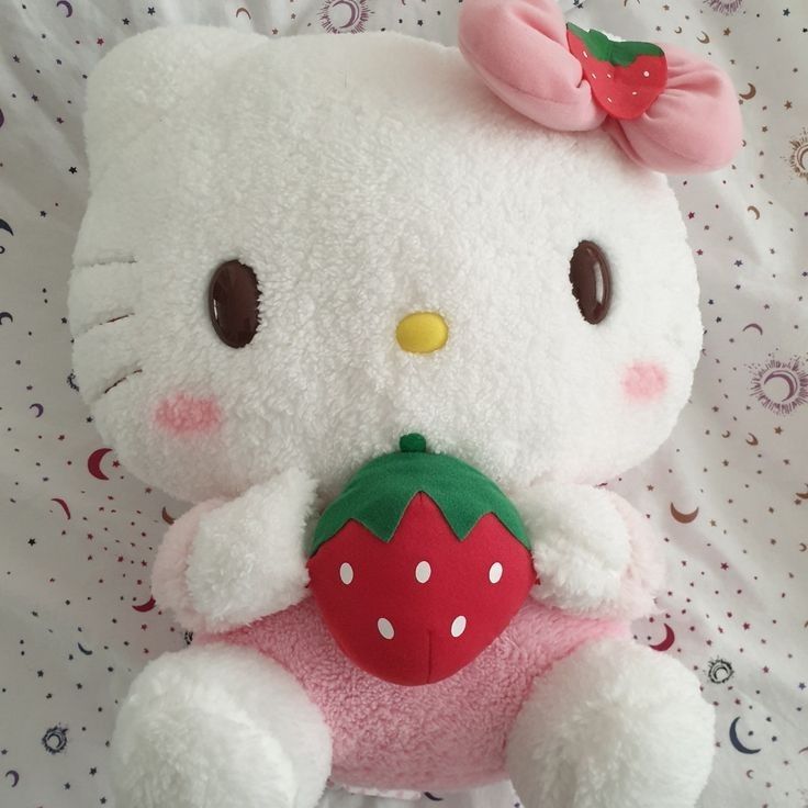 a hello kitty stuffed animal holding a strawberry