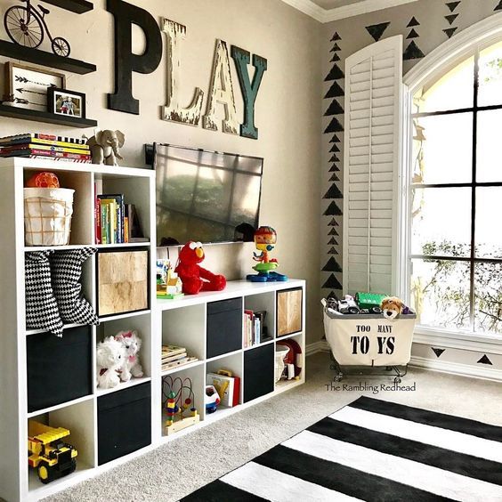 a child's room with black and white decor