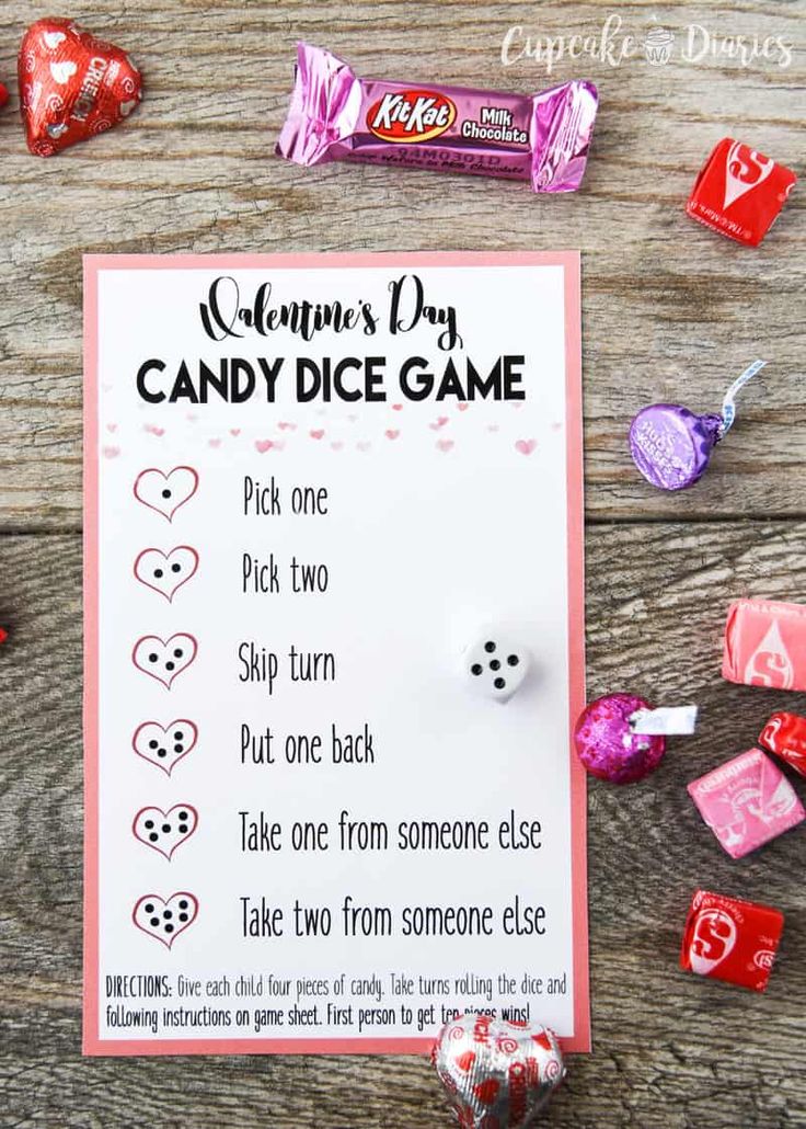 a valentine's day candy dice game on a wooden table