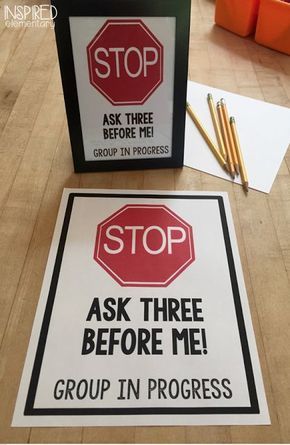 there are two signs on the table that say stop and ask three before me group in progress