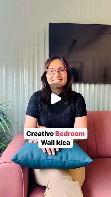 a woman sitting on a pink couch holding a blue pillow with the words creative bedroom wall idea