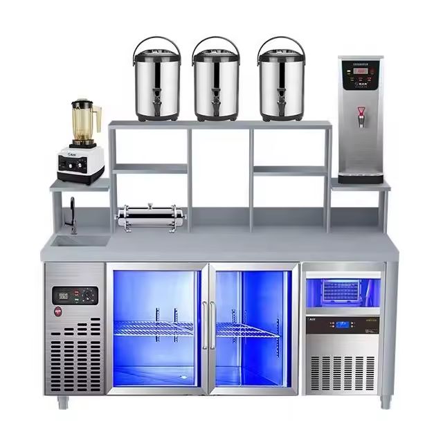 an industrial kitchen with stainless steel appliances and blue lights on the side wall, including two ice buckets