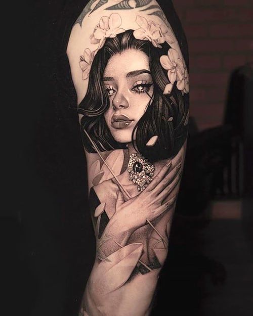 a woman's arm with tattoos on it and an image of her face in the middle