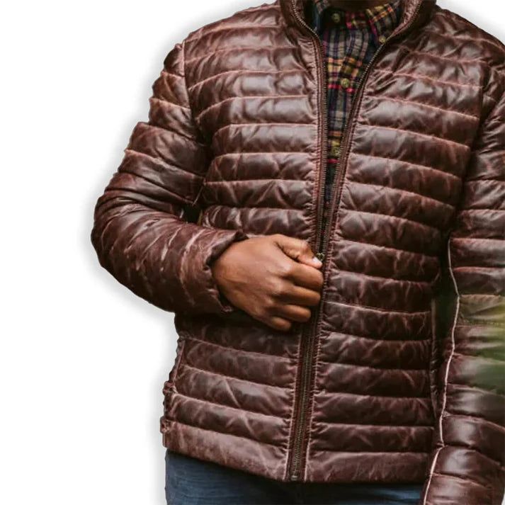 Rugged style meets winter warmth in our Men's Brown Leather Puffer Jacket. Crafted from supple, genuine leather with a rich brown hue, this jacket features quilted puffer insulation for superior heat retention. The classic silhouette is enhanced with a stand-up collar, zippered front, and snug cuffs to keep the cold at bay. Practical side pockets provide storage and hand-warming comfort. Perfect for the fashion-conscious man who doesn't compromise on functionality, this jacket seamlessly transitions from outdoor adventures to city streets. Key features: Premium brown sheepskin leather exterior for durability and style Quilted puffer design for superior insulation Adjustable hem to seal out cold air Multiple pockets for convenient storage Satin lining for a luxurious feel Premium YKK zipper Biker Shirts Women, Spiked Leather Jacket, Mens Leather Blazer, Motorcycle Leather Vest, Racer Jackets, Flannel Vest, Varsity Jacket Women, Leather Puffer Jacket, Leather Puffer