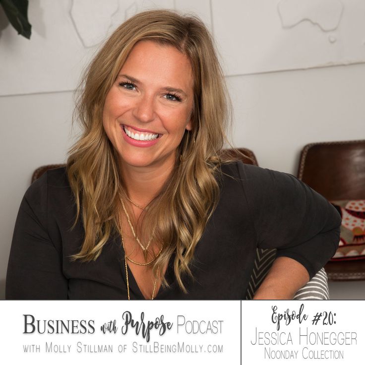 a woman sitting in a chair with her arms crossed and looking at the camera, smiling