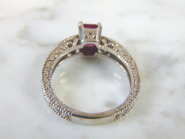 FOR SALE IS THIS LOVELY VINTAGE ESTATE 14K WHITE GOLD RING WITH AN EMERALD CUT GARNET STONE AND DIAMOND CHIPS. RING IS A SIZE 6.5 AND WEIGHS 4.9g. THERE ARE ABOUT .04cts OF DIAMONDS. THE GARNET IS ABOUT .75cts. THE RING MAKES A BEAUTIFUL GIFT FOR THAT SOMEONE SPECIAL. ANY OTHER QUESTIONS, PLEASE ASK. BE SURE TO CHECK OUT SOME OF MY OTHER GREAT ITEMS UP FOR SALE. THANK YOU Estate White Gold Rings For Gift, Estate Style White Gold Rings As Gift, Antique Diamond Cut Ruby Ring For Anniversary, Antique Ruby Ring With Diamond Cut For Anniversary, Vintage Hallmarked White Gold Ruby Ring, Hallmarked Vintage White Gold Ruby Ring, Victorian Ruby Ring With Diamond Cut For Anniversary, Vintage Ruby Ring With Accent Stones For Anniversary, Heirloom Emerald Ring With Intricate Design For Anniversary