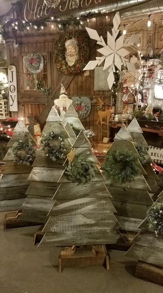 christmas trees made out of wooden planks in a shop