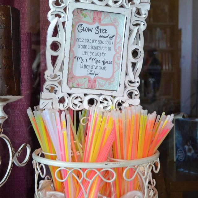 there are many different colored straws in the cup on the shelf next to the mirror