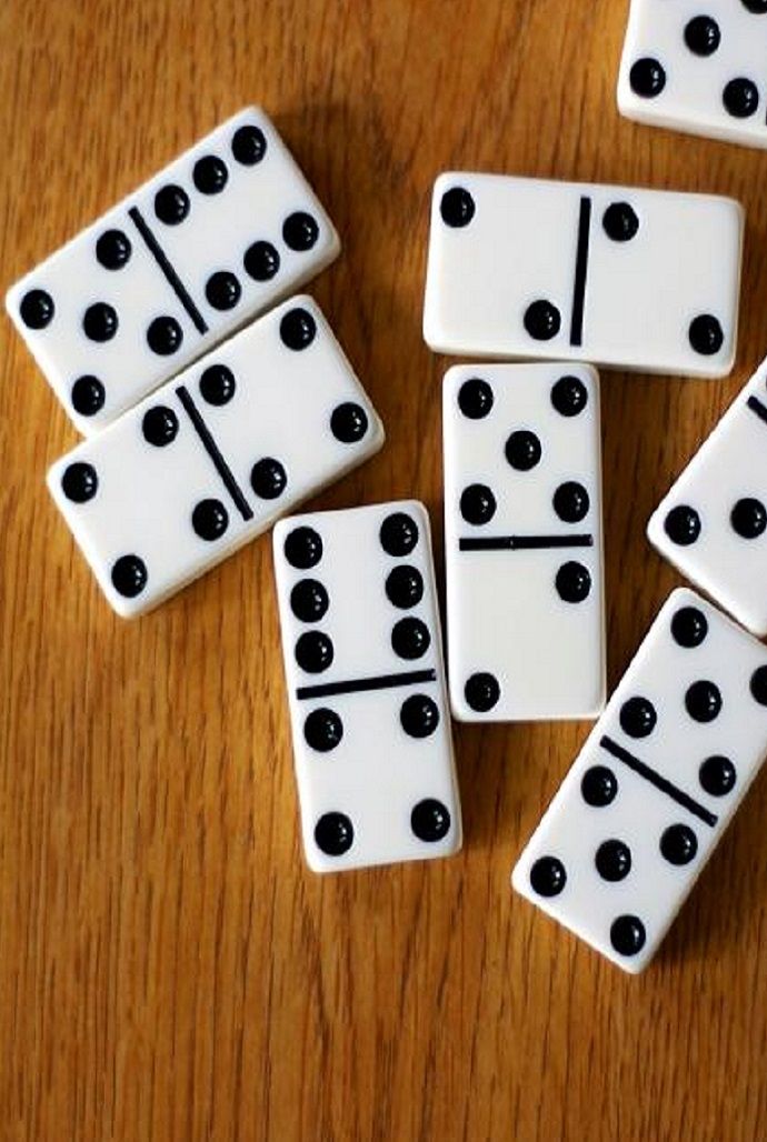 white dominos with black dots on them sitting on a table