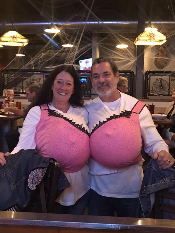 a man and woman in pink bras standing next to each other