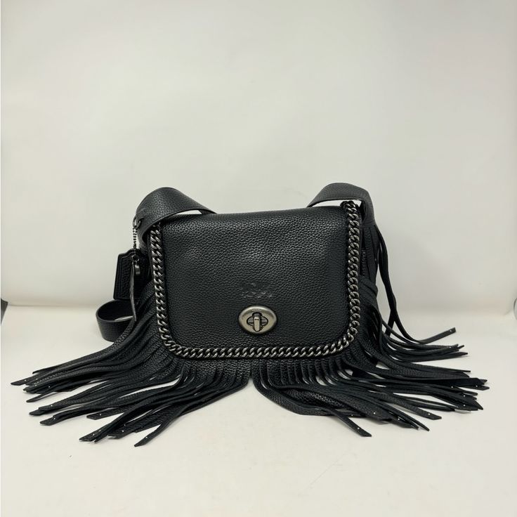 Black Pebbled Leather Fringe Chain Link Accent Gunmetal Hardware Turn Lock Closure Nylon Lining Original Dust Bag Included Measurement (In): Height: 9.5" Width: 11.75" Depth: 2.5" Strap Length: 19" Condition: Pre-Loved Condition Grade: A Exterior: Minor Scratches To Hardware Interior: No Significant Signs Of Wear Coach 1941, Gunmetal Hardware, Black Pebbles, Leather Fringe, Pebbled Leather, Chain Link, Dust Bag, Bag Lady, Exterior