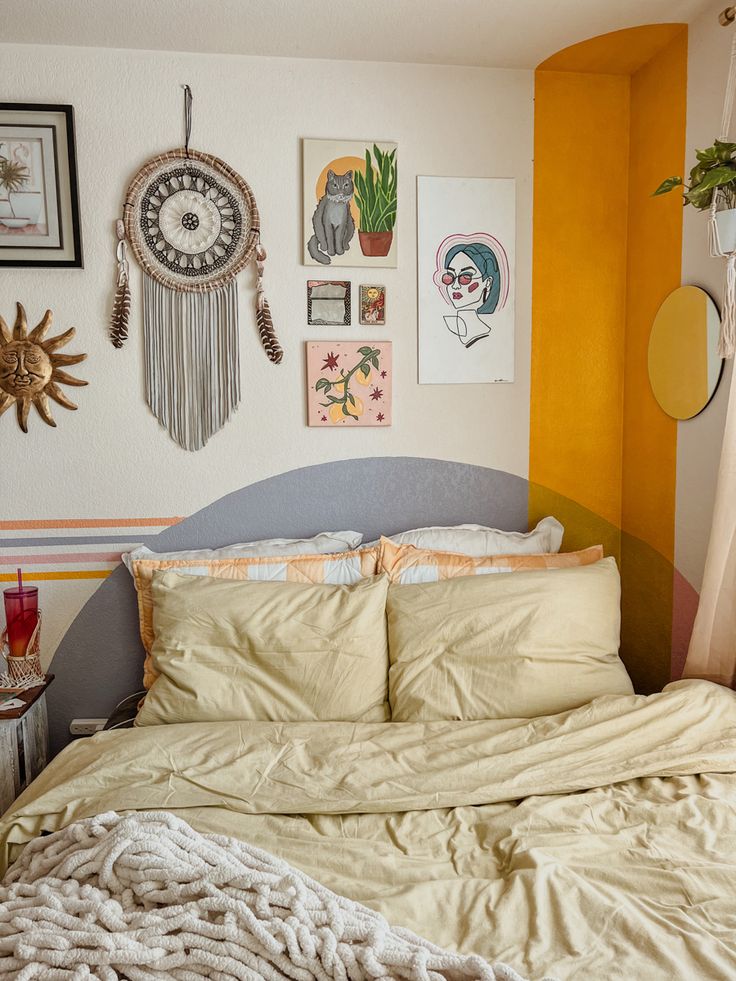 a corner of a bedroom featuring a painted headboard, gallery wall with dream catcher, mirrors, and paintings. Corner Bed Painted Headboard, Over The Bed Wall Decor Eclectic, Painted On Headboard Wall Art, Bedroom Painted Headboard, Faux Headboard Painted On Wall, Boho Corner Wall Painting Ideas, Behind Bed Mural, Simple Bedroom Mural Ideas, Guest Room Mural