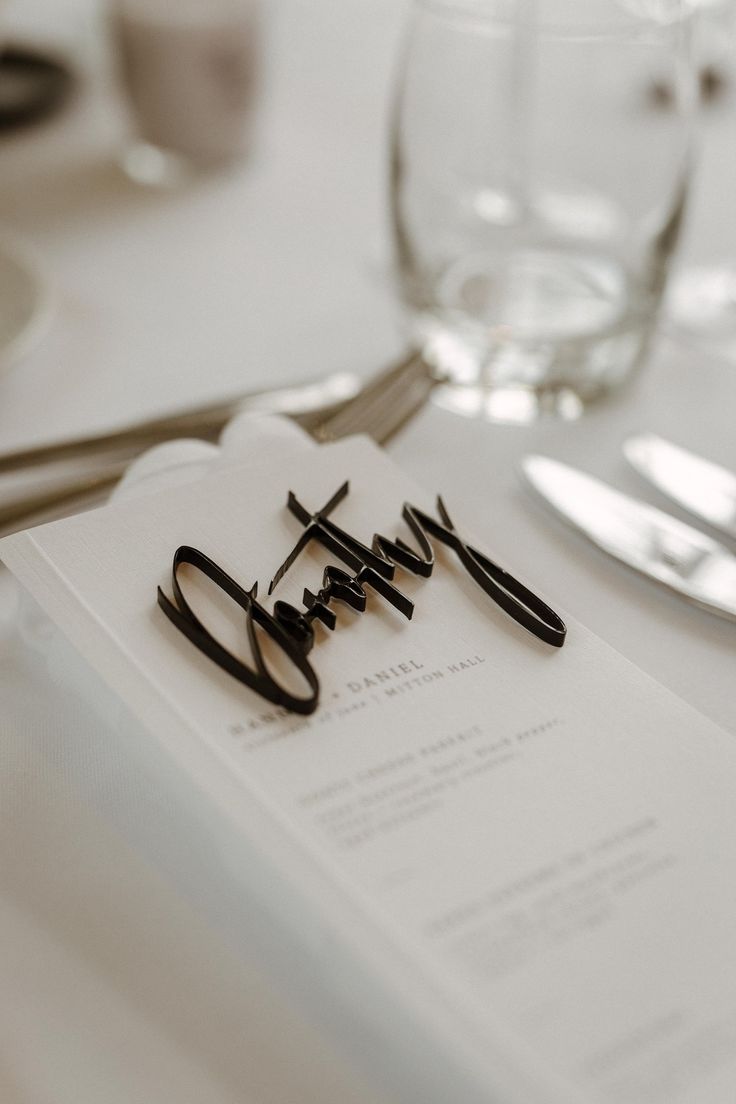 the table is set with silverware and place settings